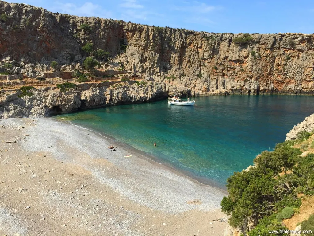 View of the golden sands and turquoise Mediterranean Sea at Menies Beach, located in Crete.